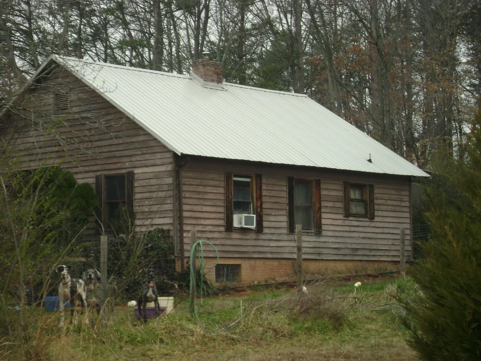 White metal roof on an old wood sided farmhouse, from a Metal Roof Installation job in Holbrook